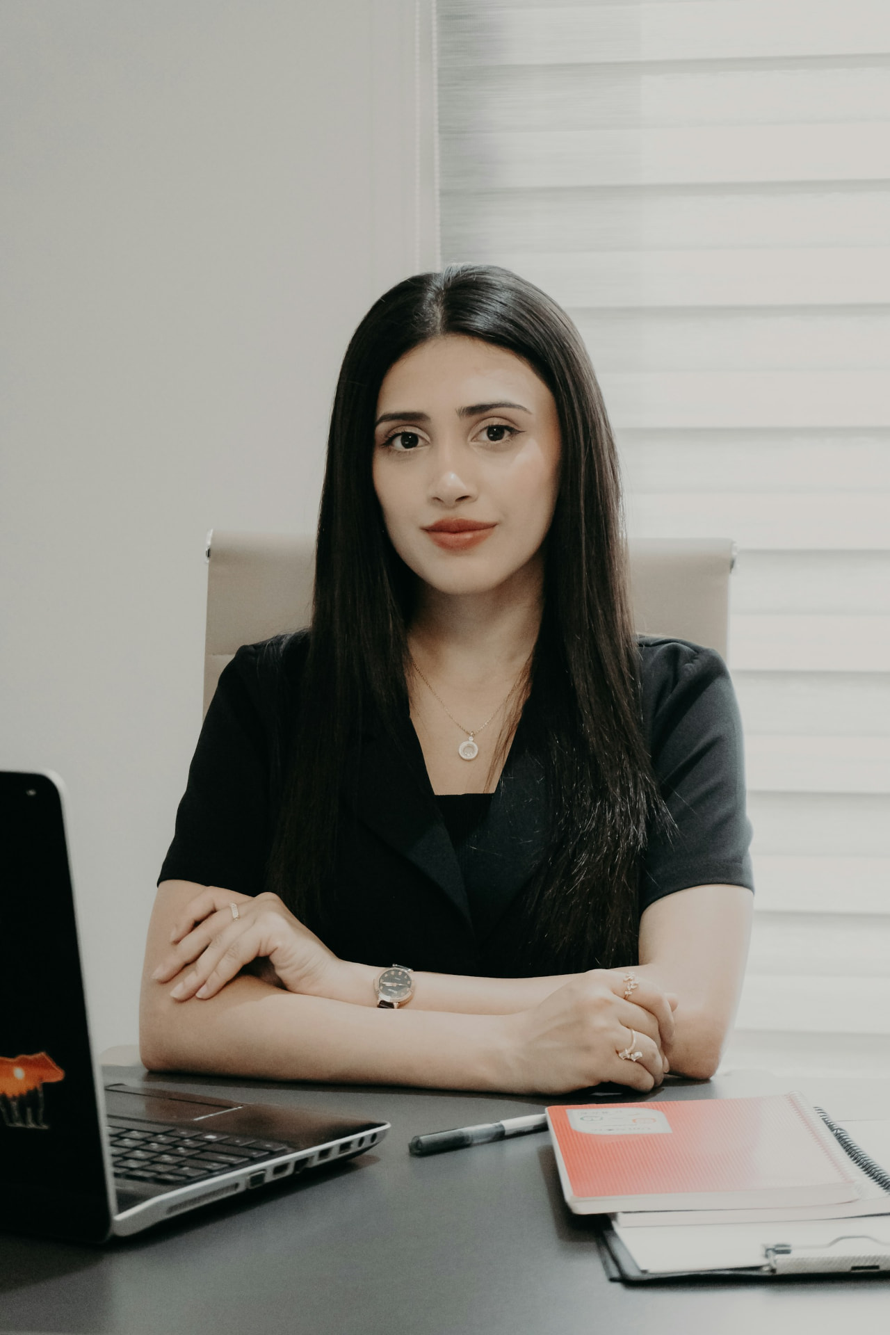 Marissa De Jesus, mobile notary public, seated at her desk